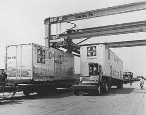 © Photo: Orville Brent, Jr. Truck trailers from the Atchison, Topeka and Santa Fe Railway are being loaded on to flat cars for piggyback service at Hobart Yards in Los Angeles, California. The dual flat cars have the ability to handle either containers or trailers, or a combination of both.
