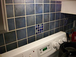 Tiling in kitchen above stove and countertop.jpg